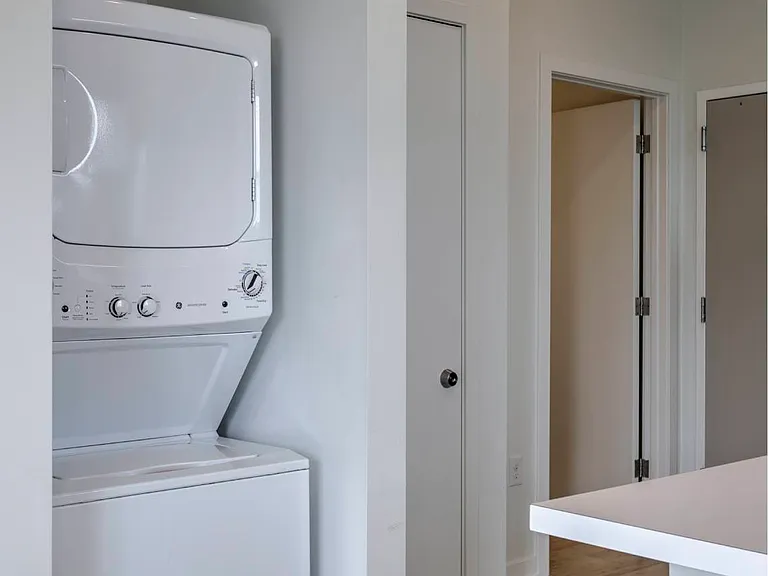 Stacked washer and dryer in a unit at The Rise.