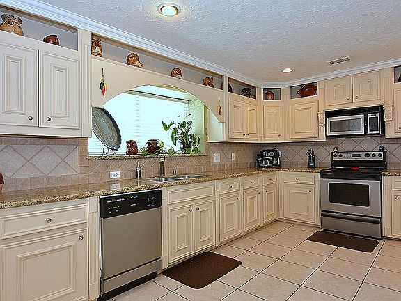 A CHEF'S DREAM COME TRUE. EACH OF THESE KITCHEN CABINETS WERE CUSTOM BUILT. FEATURING GRANITE COUNTE