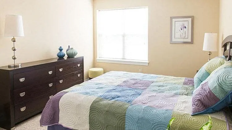 Spacious bedroom with large, bright windows