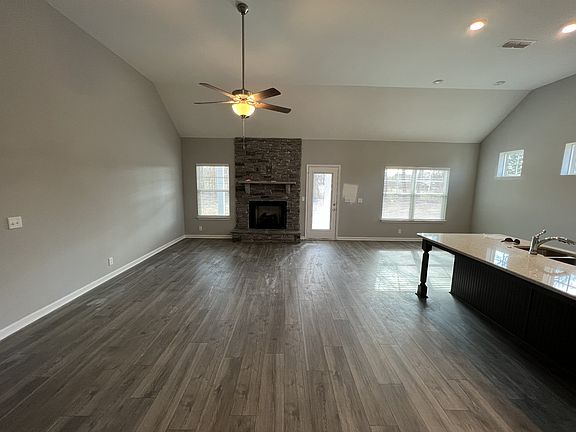 looking at the great room from the foyer, gas log fireplace, ceiling fan, cable jack