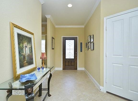 A glass entry door welcomes you inside, where off the Foyer resides Two Guest Bedrooms flanking a sp