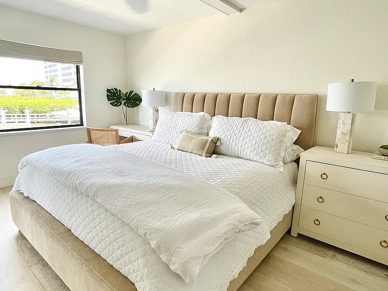 Primary bedroom with blackout shades and king bedroom. Desk that can be moved in front of window overlooking bay - a favorite spot for remote workers and digital nomads