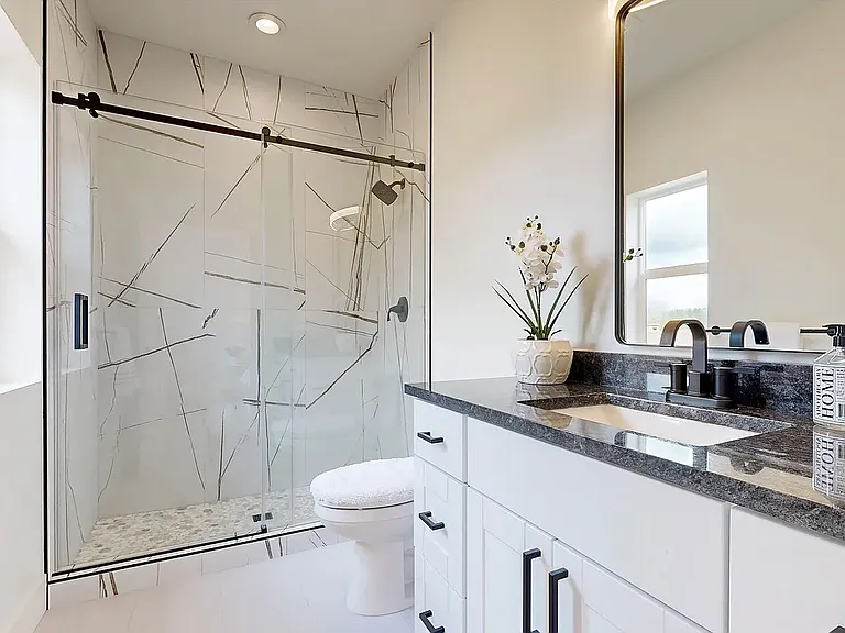 A luxurious ensuite bathroom designed with elegant finishes, creating a refined and relaxing retreat.
