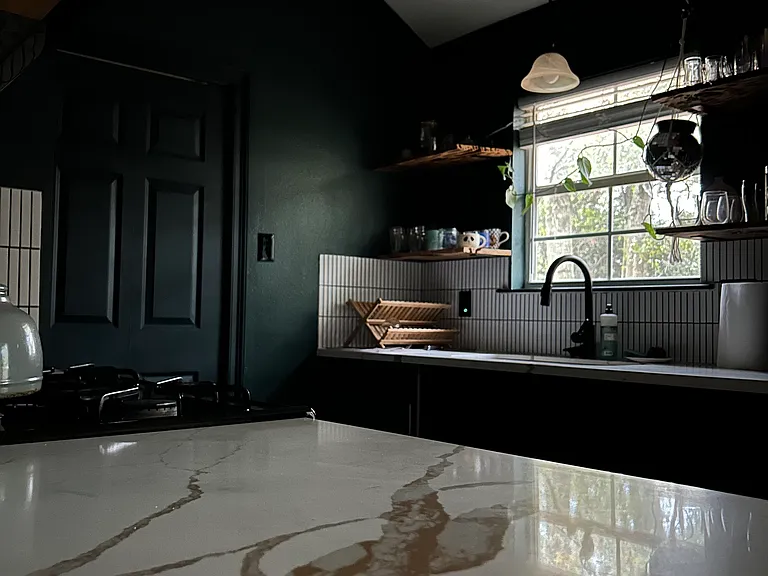 Kitchen has cypress shelving on the top and cabinets on the bottom