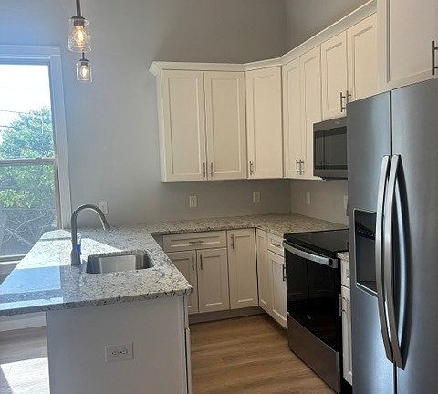 Kitchen has bar seating, quartz countertops, 42" upper cabinets and Whirlpool appliances