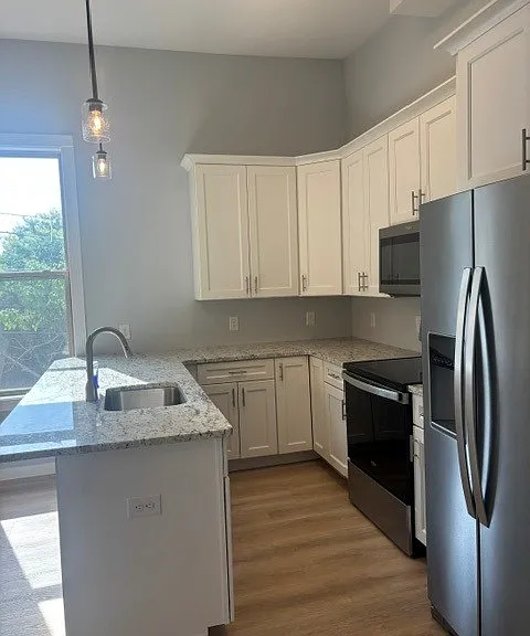Kitchen has bar seating, quartz countertops, 42" upper cabinets and Whirlpool appliances