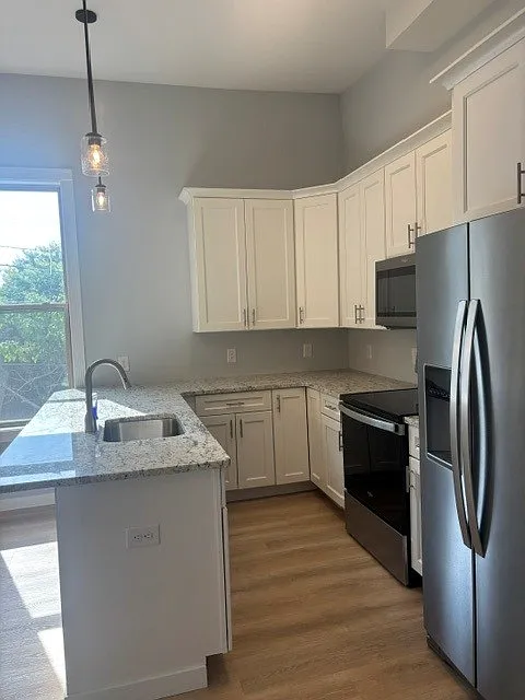 Kitchen has bar seating, quartz countertops, 42" upper cabinets and Whirlpool appliances