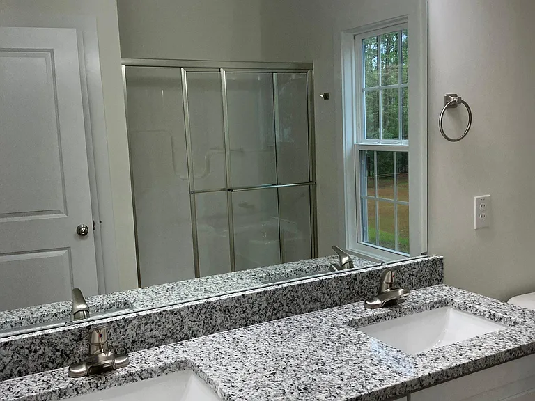 Master Bathroom. Granite tops. large Linen closet and shower with seat. LVP flooring.