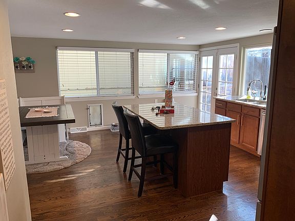 Eat-in kitchen with large island and matching stainless steel appliances. French doors to backyard.