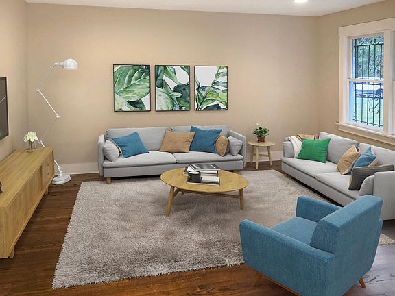 Large living room with lots of light and open to the kitchen.