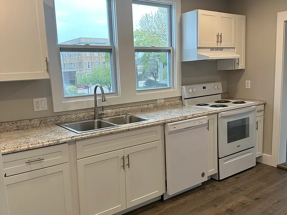 Kitchen with dishwasher, range and refrigerator. Great windows looking west toward the lake and downtown St. Joseph.