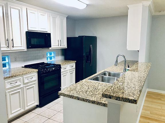 Kitchen complete with fridge, gas stove, microwave, waste disposal and dishwasher.