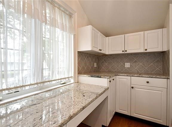 Spacious office with storage cabinets and cedar closet.