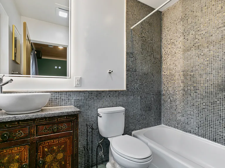En suite bath with custom slate tile, Toto toilet, grohe fixtures, lighted mirror/ 100 yo converted Chinese cabinet lav.