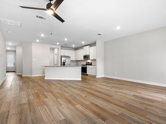 This open floorplan features a connected front room and kitchen!