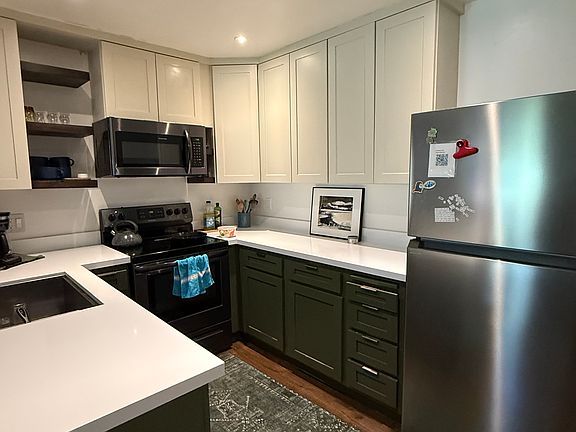 Upgraded kitchen has all the cookware you need to make a great post-outdoor meal. Quartz countertops and a fast-response electric range provide easy prep and clean surfaces, and an open counter means you aren't alone while cooking!