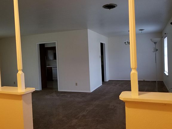 Living room towards dining area. Front entry is NOT Yellow.