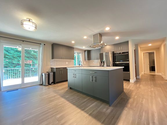 Remodeled kitchen with stainless steel appliances. Premium Wolf cooktop/ oven.