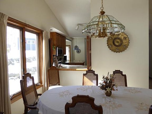 DEFINITELY DRAMATIC Dining in spacious main living area,vaulted,flooded with plenty of natural light! Convenient kitchen"pass thru"can be closed off to hide the clutter.