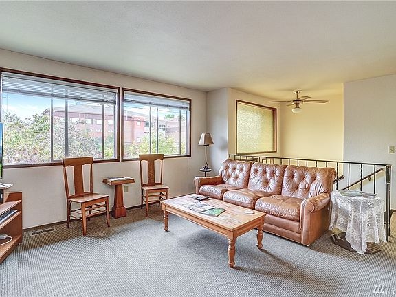 The living room has a nice open feel with two large picture windows bringing in the natural light. 