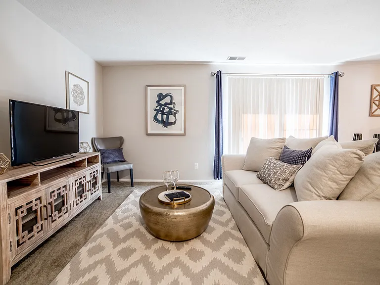 Living Room with a sliding door to the patio/balcony at Chelsea Village Apartments
