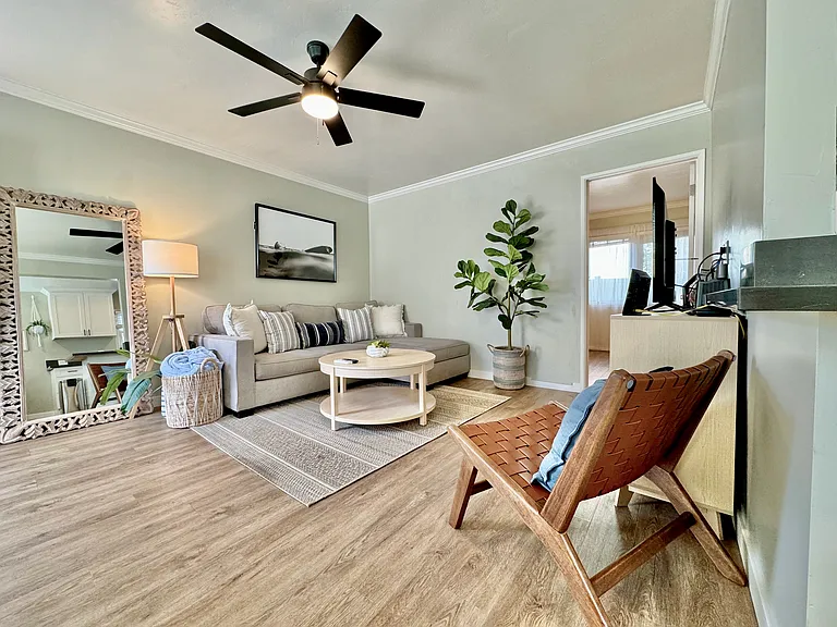 Comfortable living area with workspace, ceiling fan, air conditioning/heater mini split, wifi, and Roku TV with Netflix and Hulu