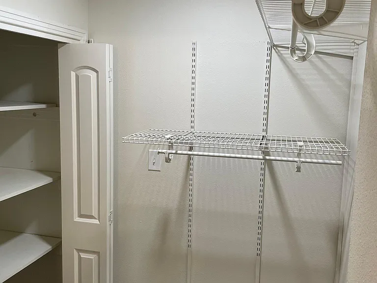Primary bedroom walk-in closet