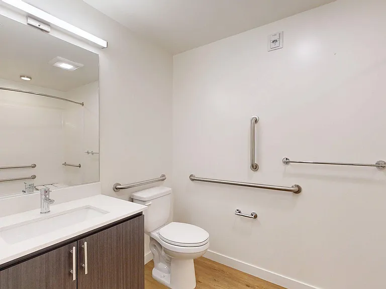 Apartment Bathroom with large soaking tub and wood-style flooring.