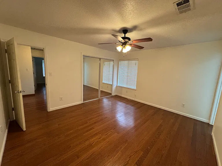 Primary bedroom with view of sliding glass closet