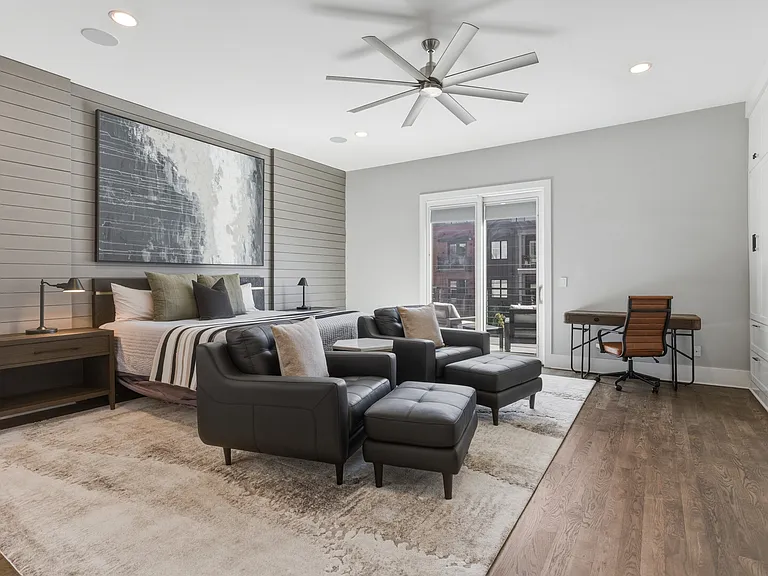 Spacious primary suite featuring a plush king bed, cozy seating area, walk-in closet with custom built-ins, spa-like bath, smart TV and private access to an 11x9 deck. Your private retreat to unwind in comfort.