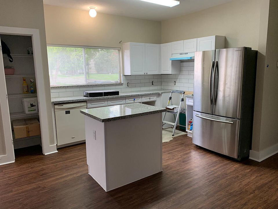 Kitchen with new countertops and backsplash. Renovation almost complete. Nice view out window. Fridge is optional.