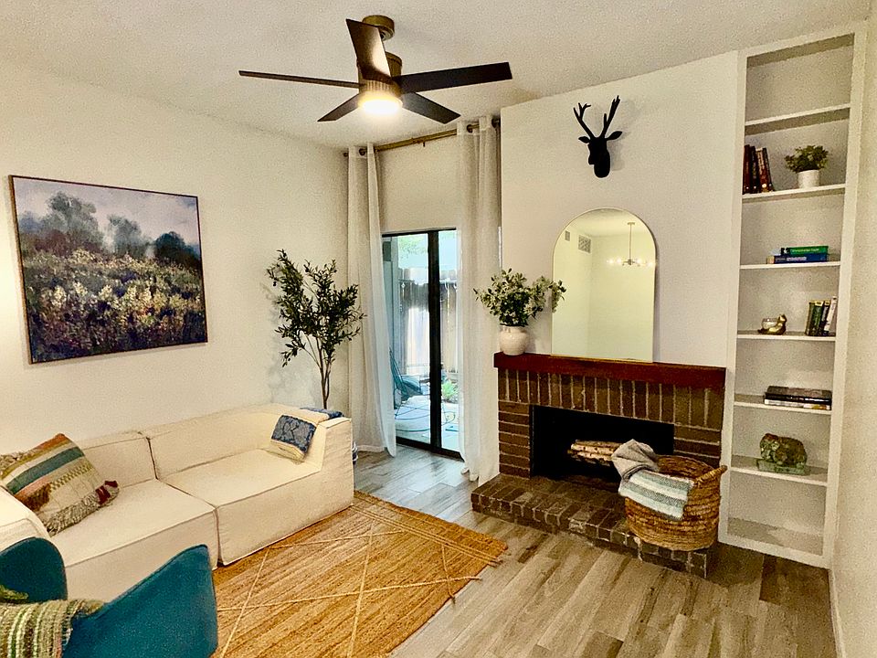 Spacious living room with built in book case, working fire place and walk out patio