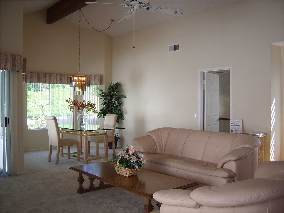 Large open living and dining area with cathedral ceilings & plenty of windows