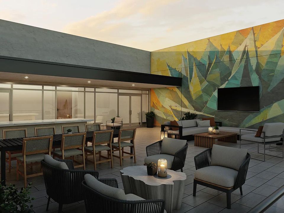Rooftop lounge with lush landscaping and comfortable seating.