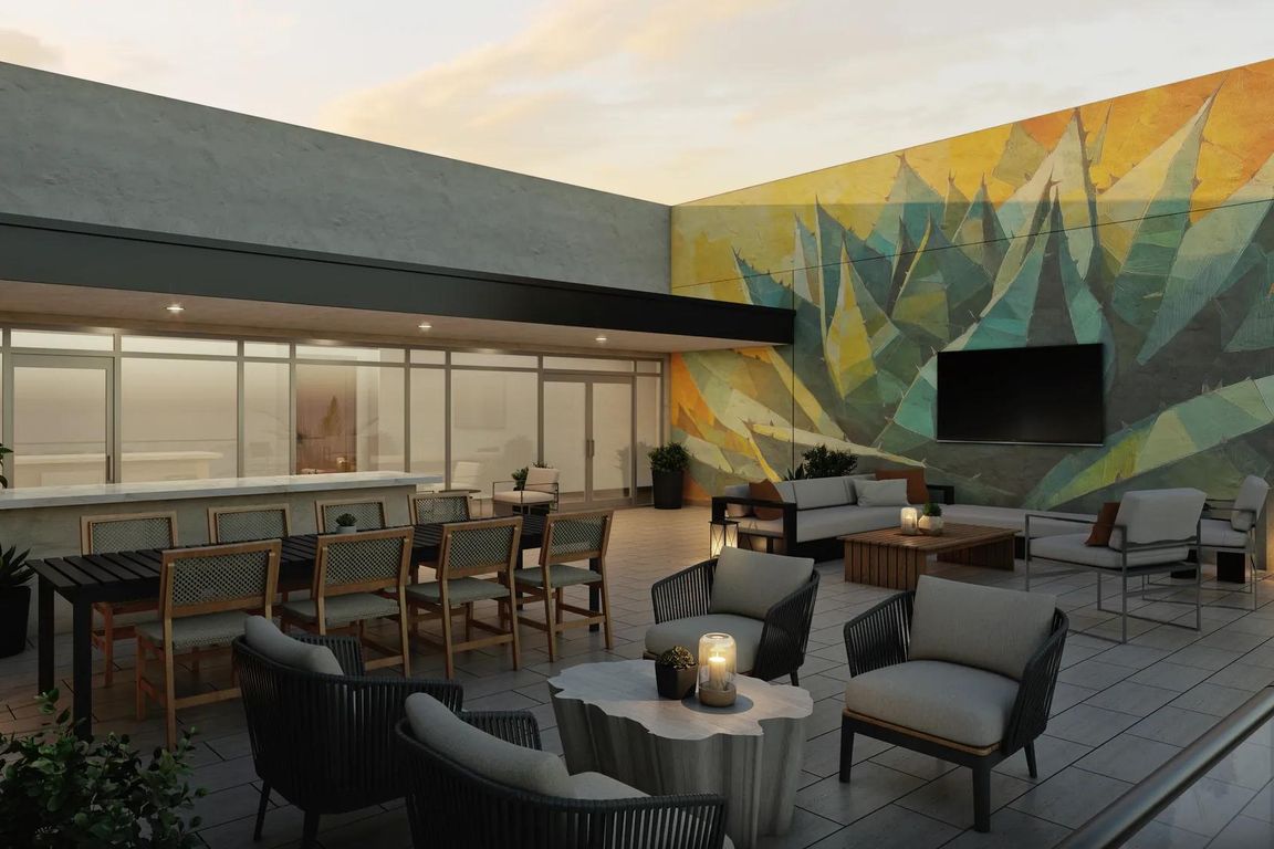 Rooftop lounge with lush landscaping and comfortable seating.
