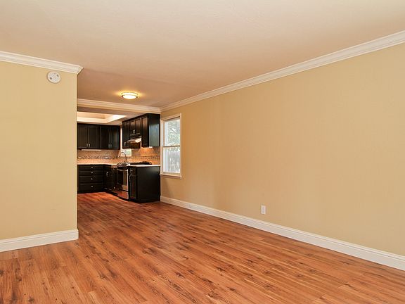 Open concept living area with serene views to yard