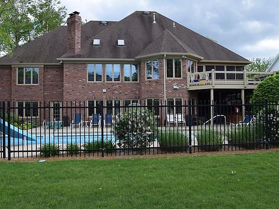 Incredible family oasis in the backyard! Large heated in-ground pool, hot tub & a beautiful deck overlooking it all!