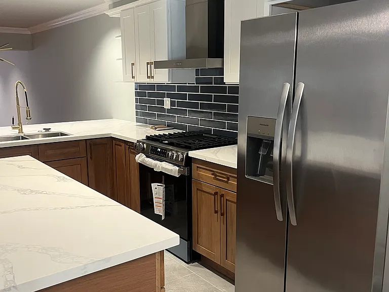 New White Oak kitchen with large quartz countertops and stainless steel appliances