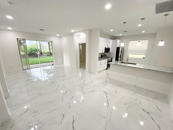 Great open spaces featuring modern South beach-style finishes. Extra-large rectified polished porcelain tiles and square baseboards.