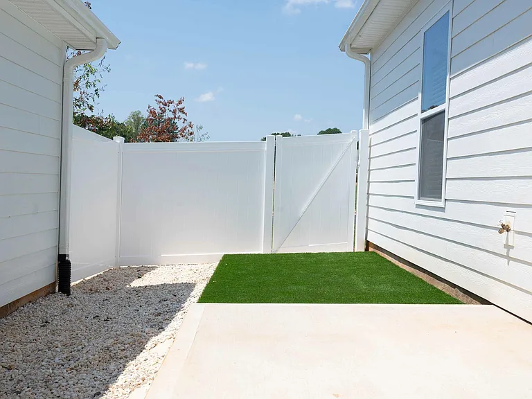 Fenced backyard with turf