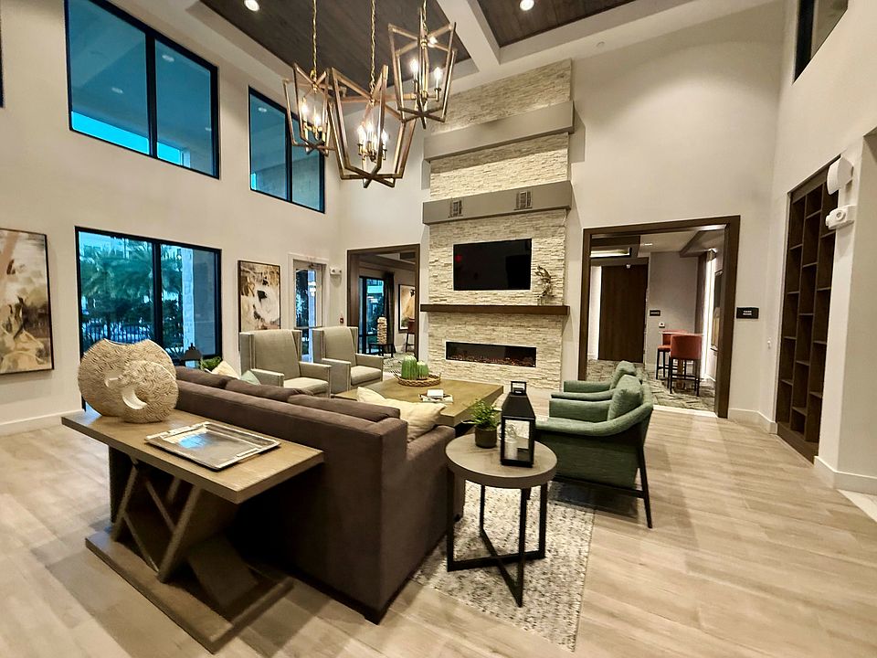Experience elegance in this modern living room, boasting upscale furnishings and ample natural light at Integra Palms.