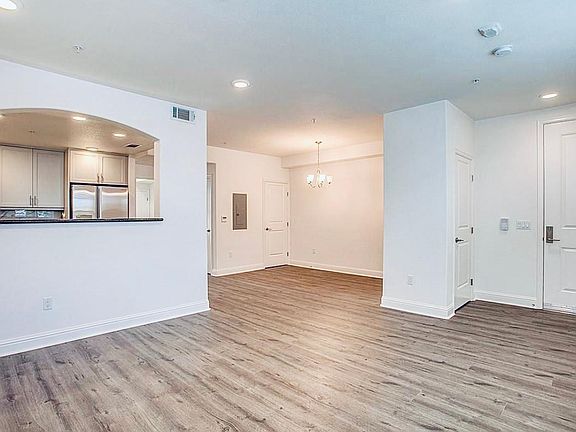 Living room, dining and kitchen. Condo entrance is through door to the right.