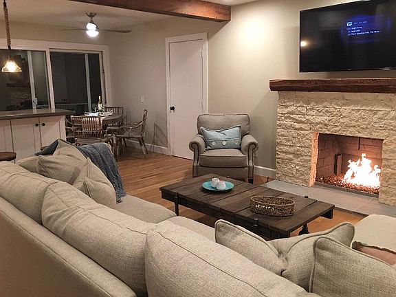 Limestone fossil fireplaces with distressed wood mantle