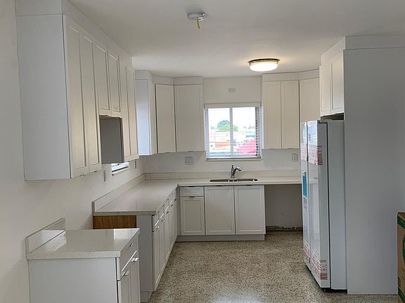 Kitchen with Newly Installed Stainless Steel appliances: dishwasher, refrigerator, stove/oven, microwave.