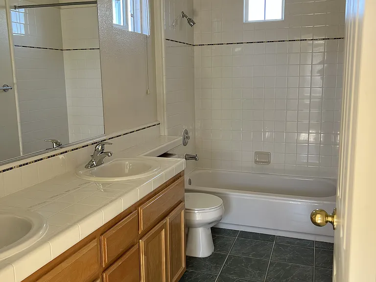 Jack & Jill bathroom with new sink faucets and new quite ceiling exhaust fan.