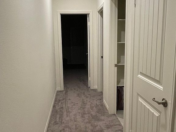 Hallway into: storage closet, laundry room, bathroom & bedroom