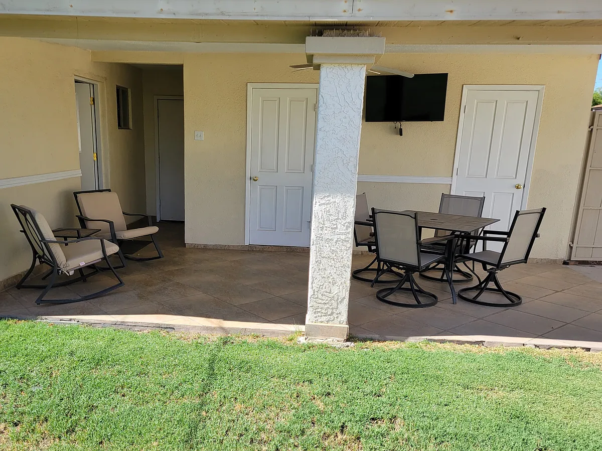 Backyard patio with television. - 823 W Romo Jones St