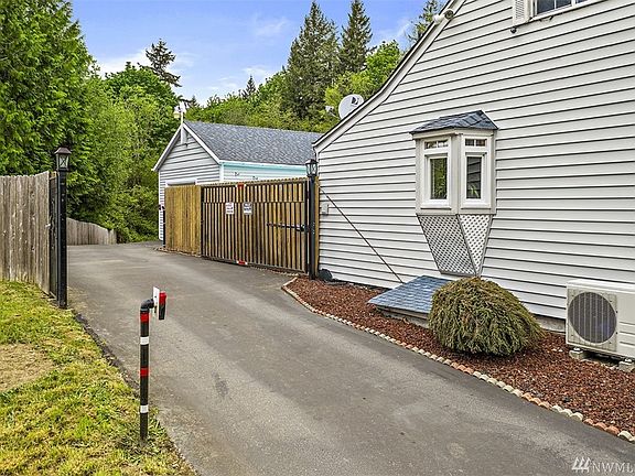 Blacktop driveway with gate. 