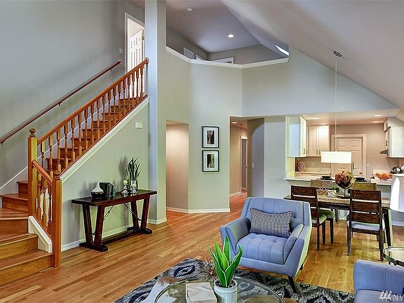 Spacious open great room with vaulted ceilings, skylights and new lighting.