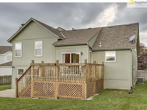 Back deck with storage area below and concrete patio